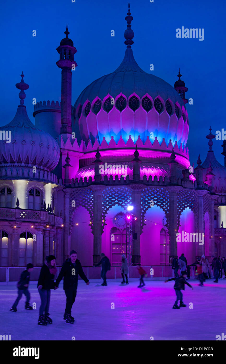 Brighton Royal Pavilion with winter ice skating rink and skaters at night, Brighton, East Sussex, England Stock Photo