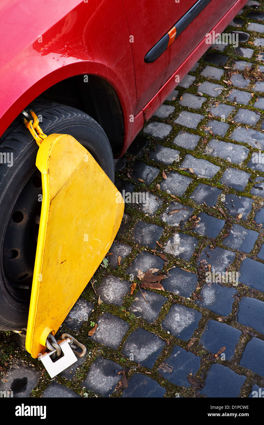 Automobile Wheel Clamp on parked car Stock Photo