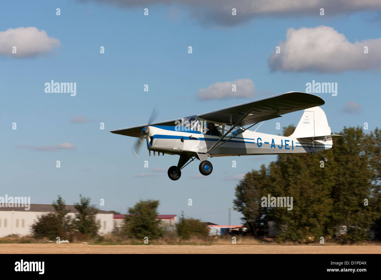 Auster J1N Alpha G-AJEI in flight taking-off from Breighton Airfield Stock Photo