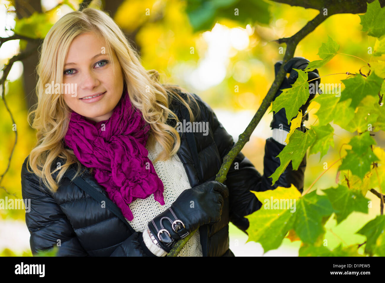 Beautiful girl leans on tree, autumn colors Stock Photo