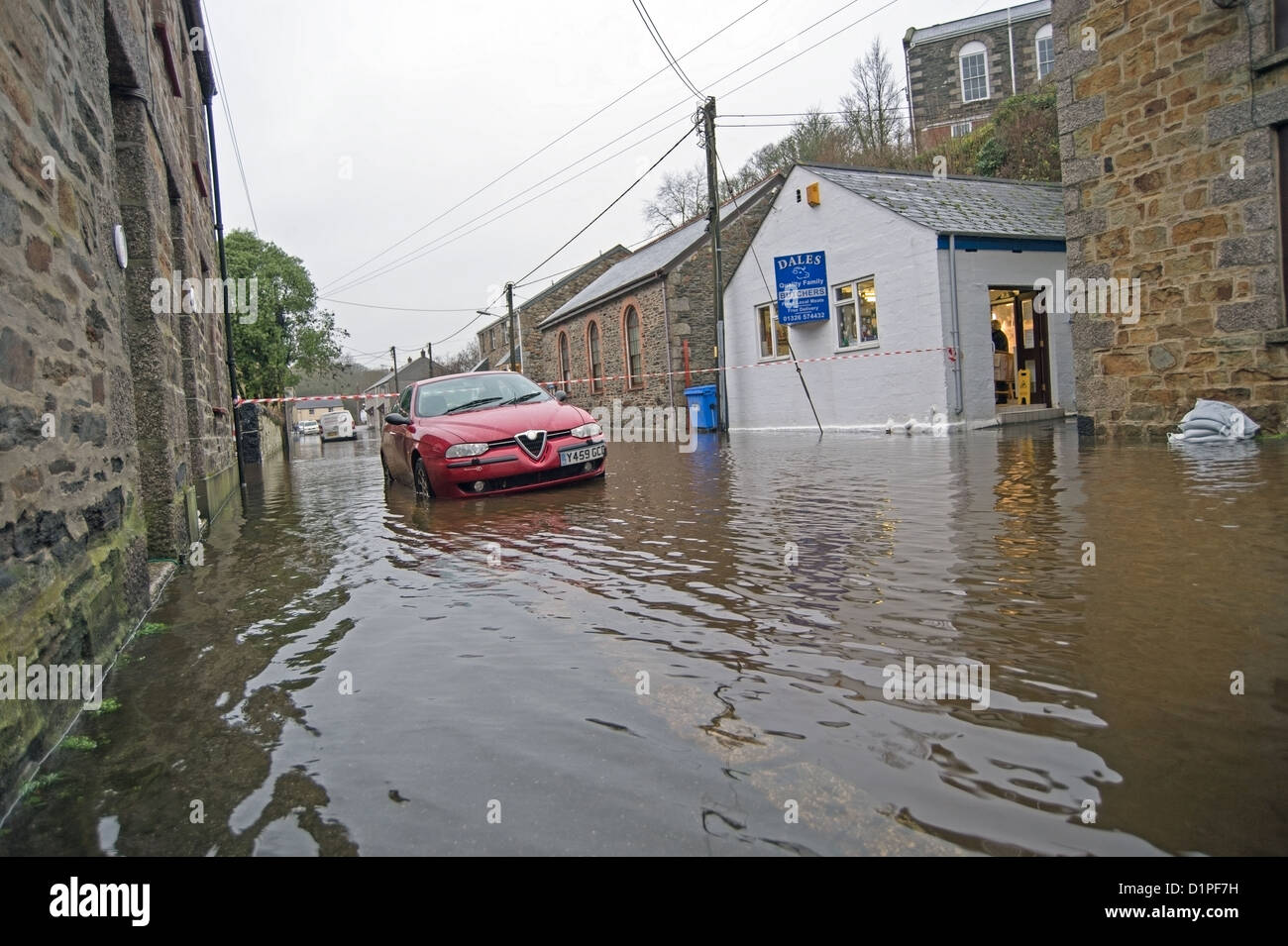 Helston Flood, car in flooded street outside butchers shop in the St Johns area of Helston Stock Photo