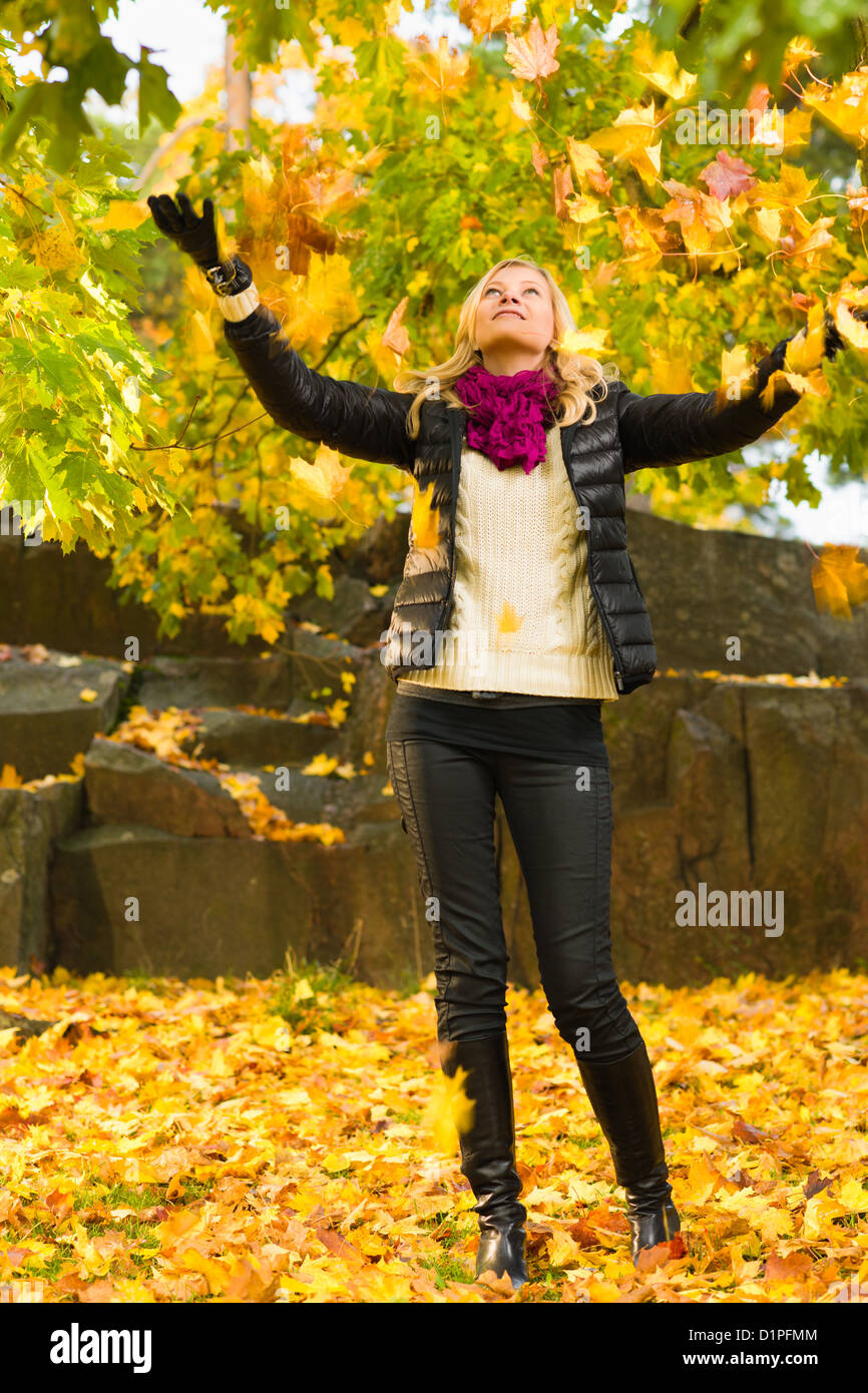 Beautiful girl and falling leaves, autumn color, vertical format Stock Photo