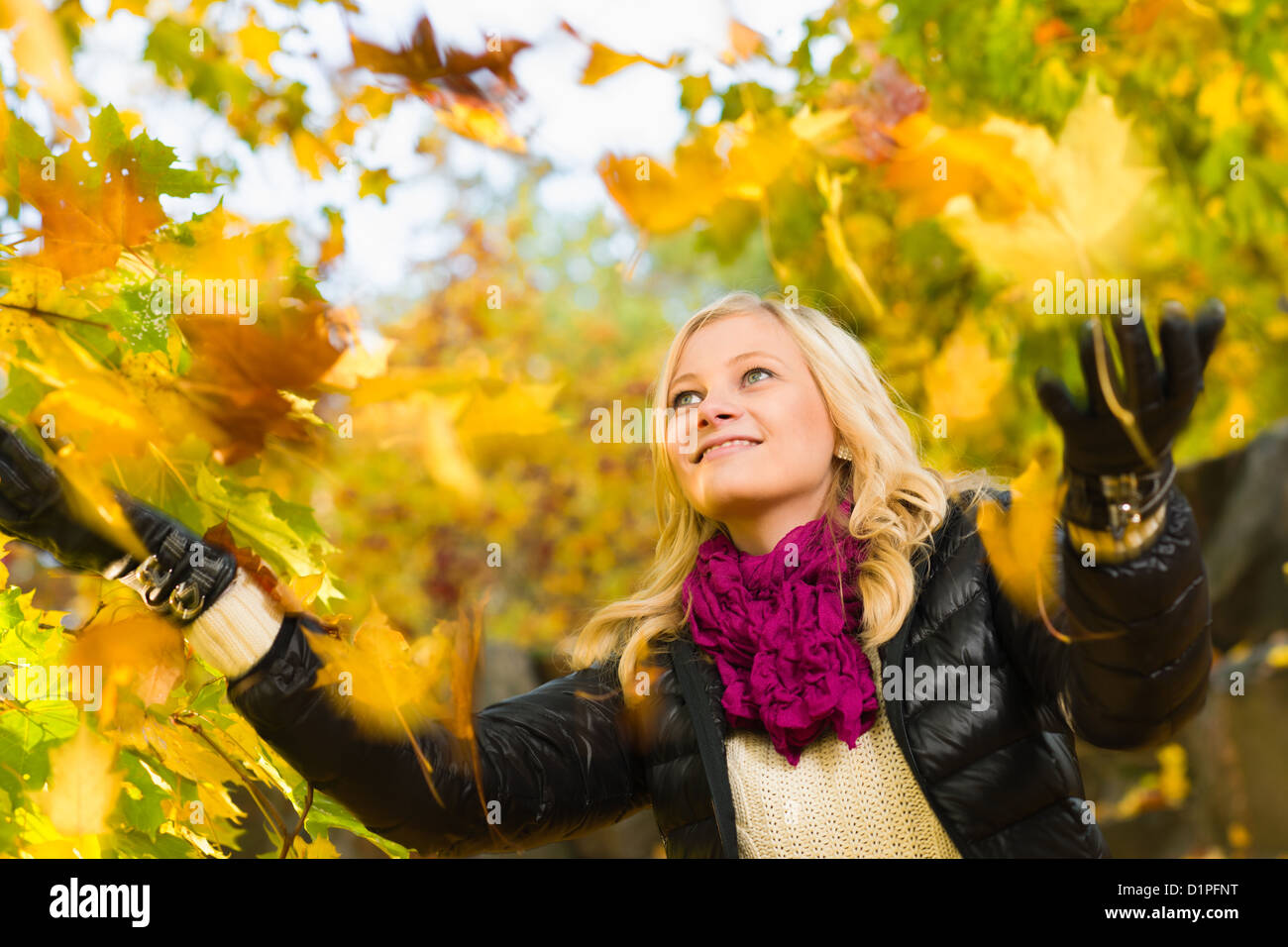 Beautiful girl and falling leaves, autumn color, horizon format Stock Photo