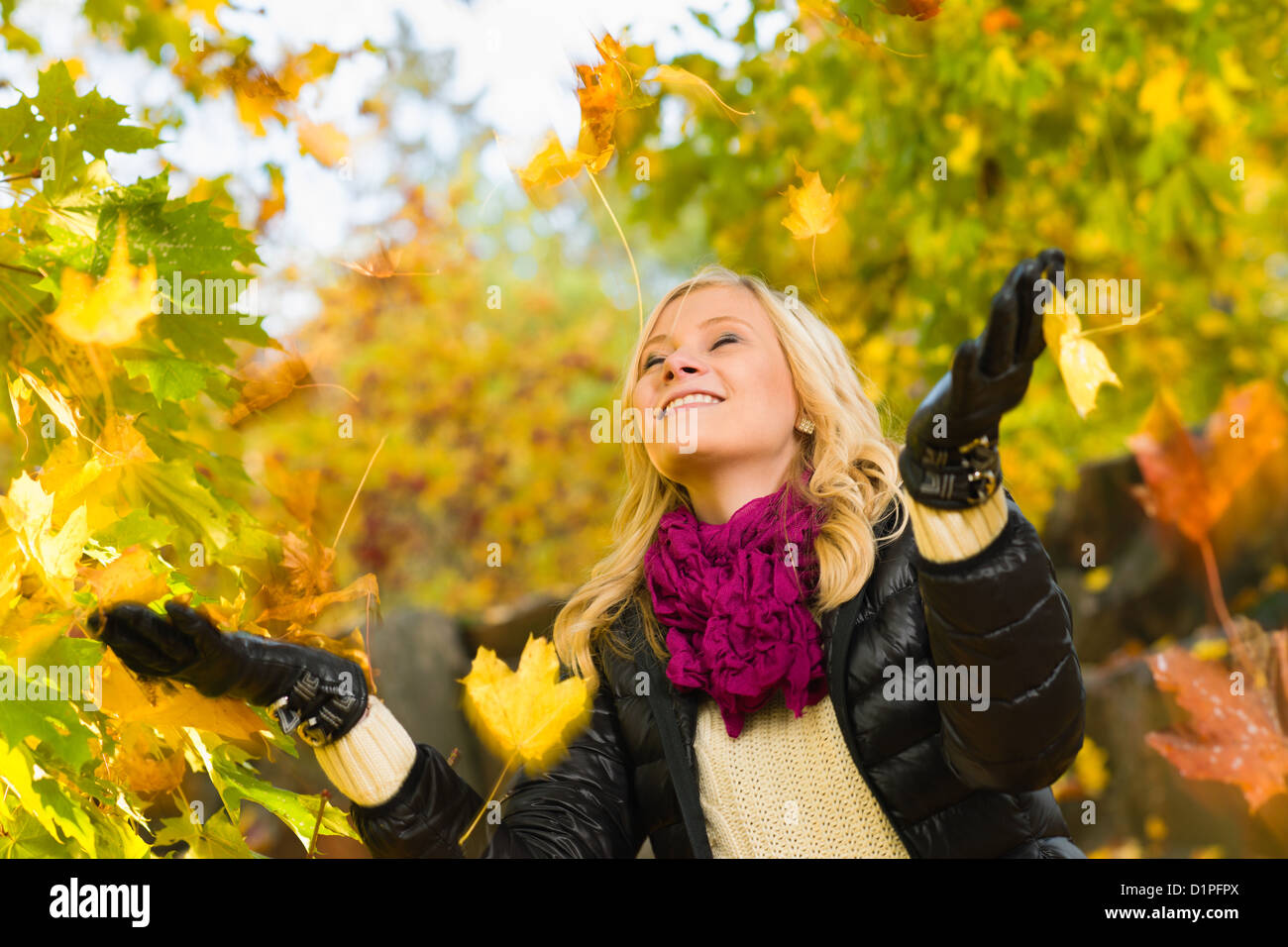 Beautiful girl and falling leaves, autumn color, horizon format Stock Photo