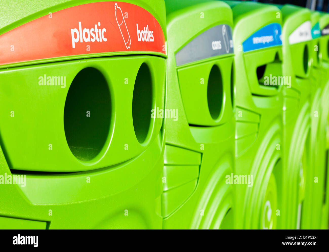 Bright green recycling bins in a row in a town centre England UK GB EU