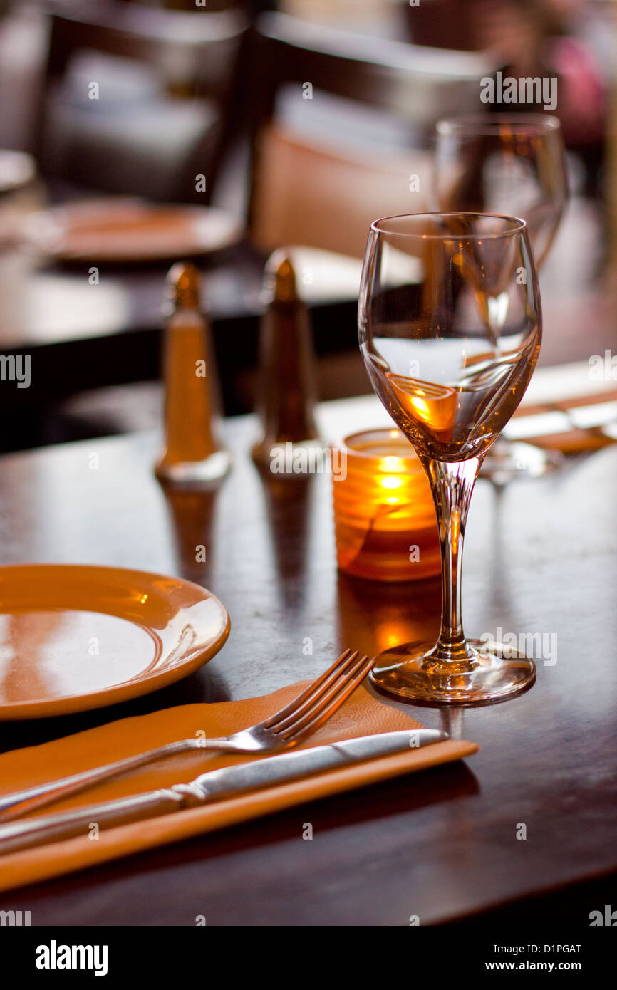 Wine glass and place setting in restaurant Stock Photo