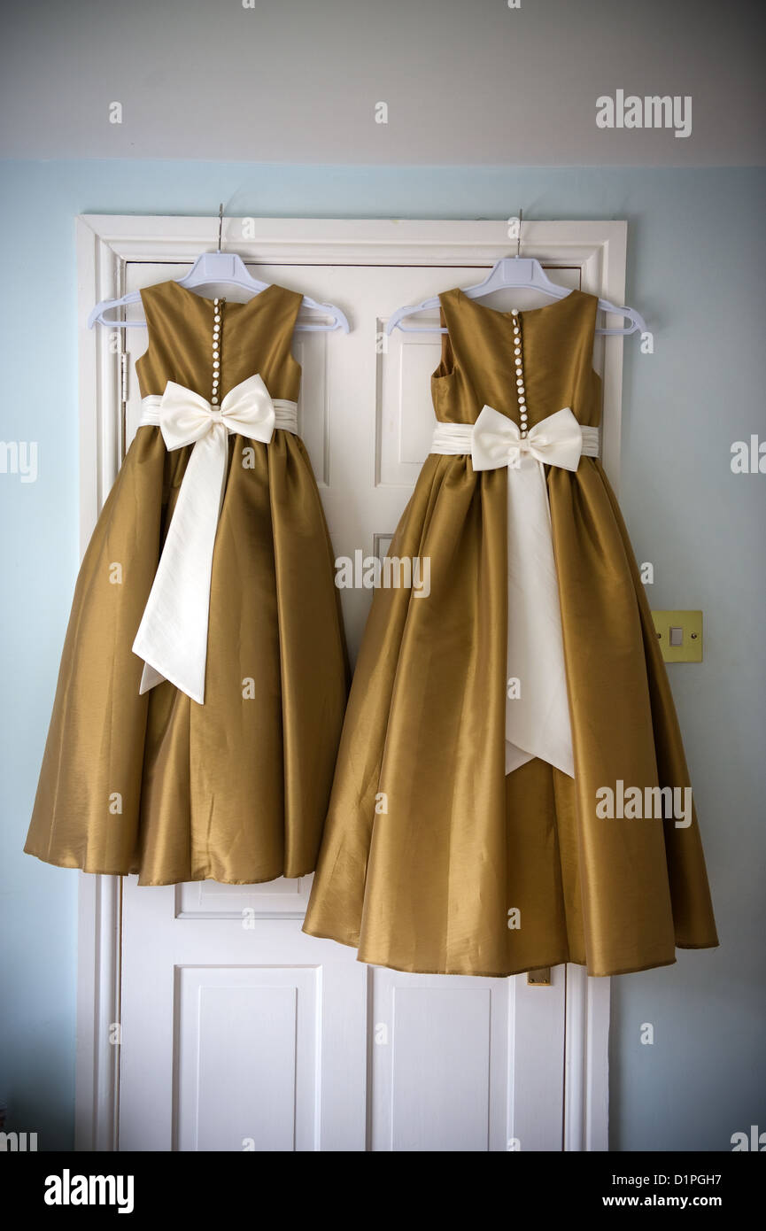 two bridesmaids dresses on hangers before a wedding Stock Photo - Alamy