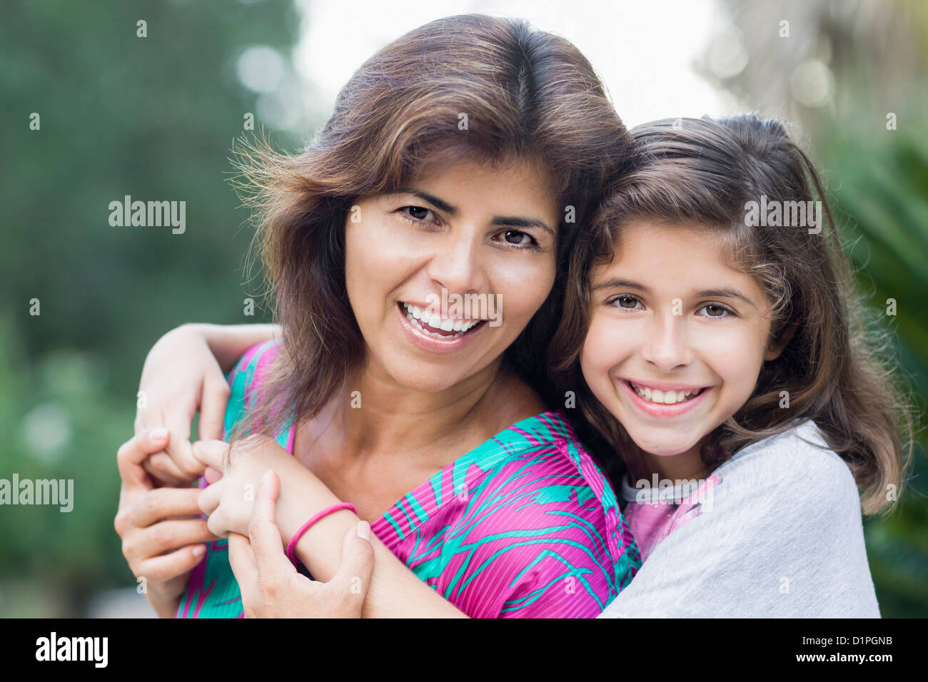 Smiling Hispanic mother and daughter Stock Photo