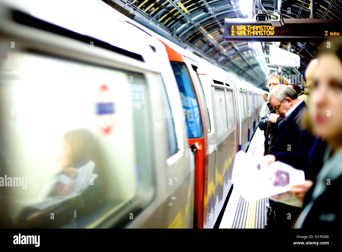 commuters on the platform as a tube train arrives on a northbound