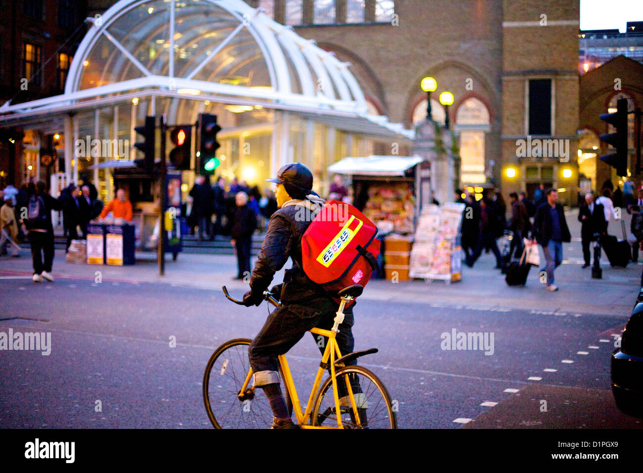 Cycle courier riding past Liverpool street train station Stock Photo Alamy