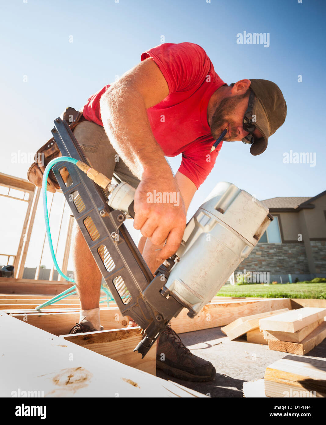 Man holding nail gun hires stock photography and images Alamy