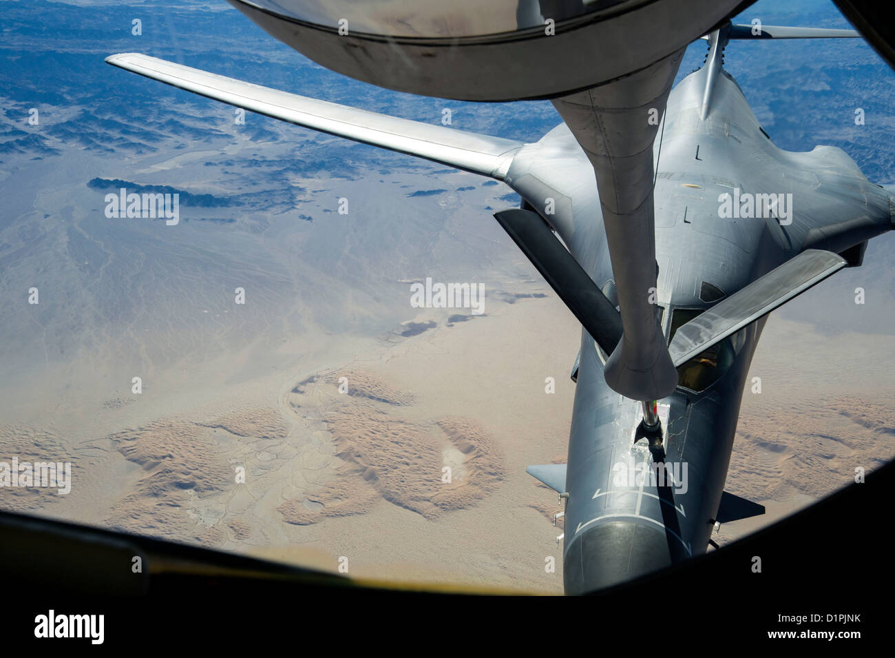 A 340th Expeditionary Air Refueling Squadron KC-135 Stratotanker refuels a B-1B Lancer over Afghanistan, Dec. 22. The B-1B, deployed from Ellsworth Air Force Base, S.D., flew 26 U.S. flags over Afghanistan for the Sandy Hook Elementary School shooting in Stock Photo