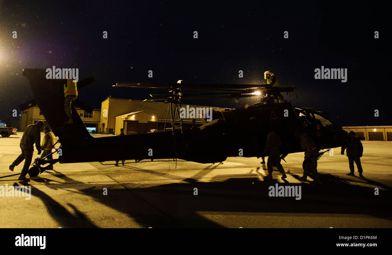 An AH-64D Apache Longbow, 1-211 Aviation Brigade from West Jordan, Utah gets pushed to it's parking spot after being removed from a C-17 Globemaster III Dec. 28, 2012, Hill Air Force Base, Utah. The Apache returned home after spending 9 months in Afghanis Stock Photo