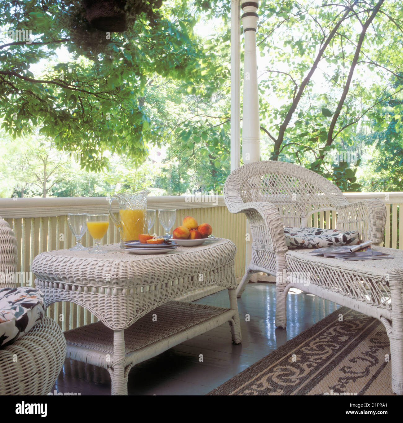 PORCHES Detail white wicker furniture a side table with juice and