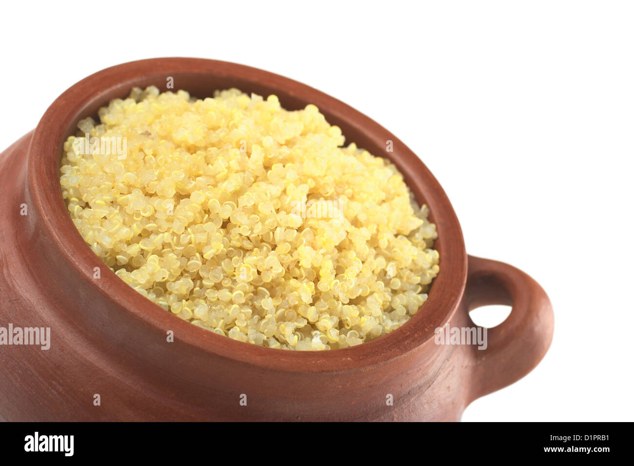 Cooked white quinoa in rustic bowl which can be eaten as a side dish like rice and is rich in proteins isolated on white Stock Photo