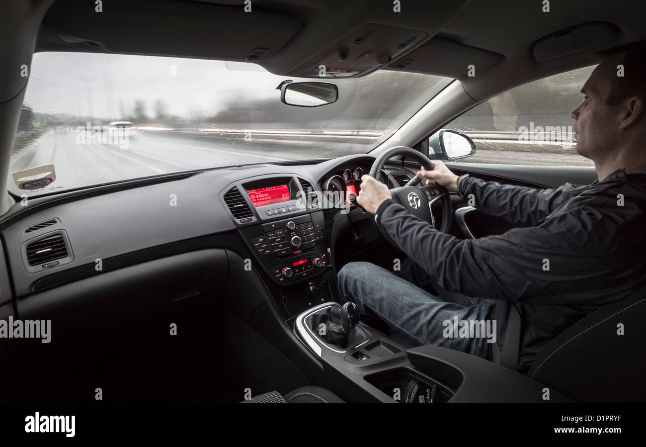 Drving fast down a motorway in the rain from inside the car. Stock Photo