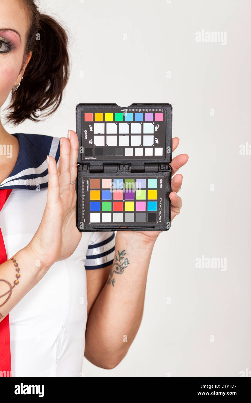 Model holding a colour chart to enable white balance to be set correctly Stock Photo