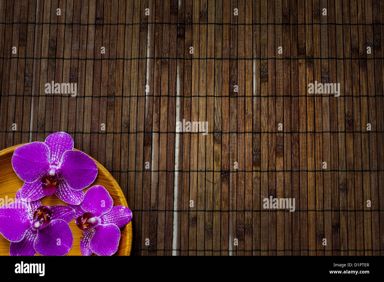 Orchid on bamboo mat spa cosmetic abstract vintage background Stock Photo