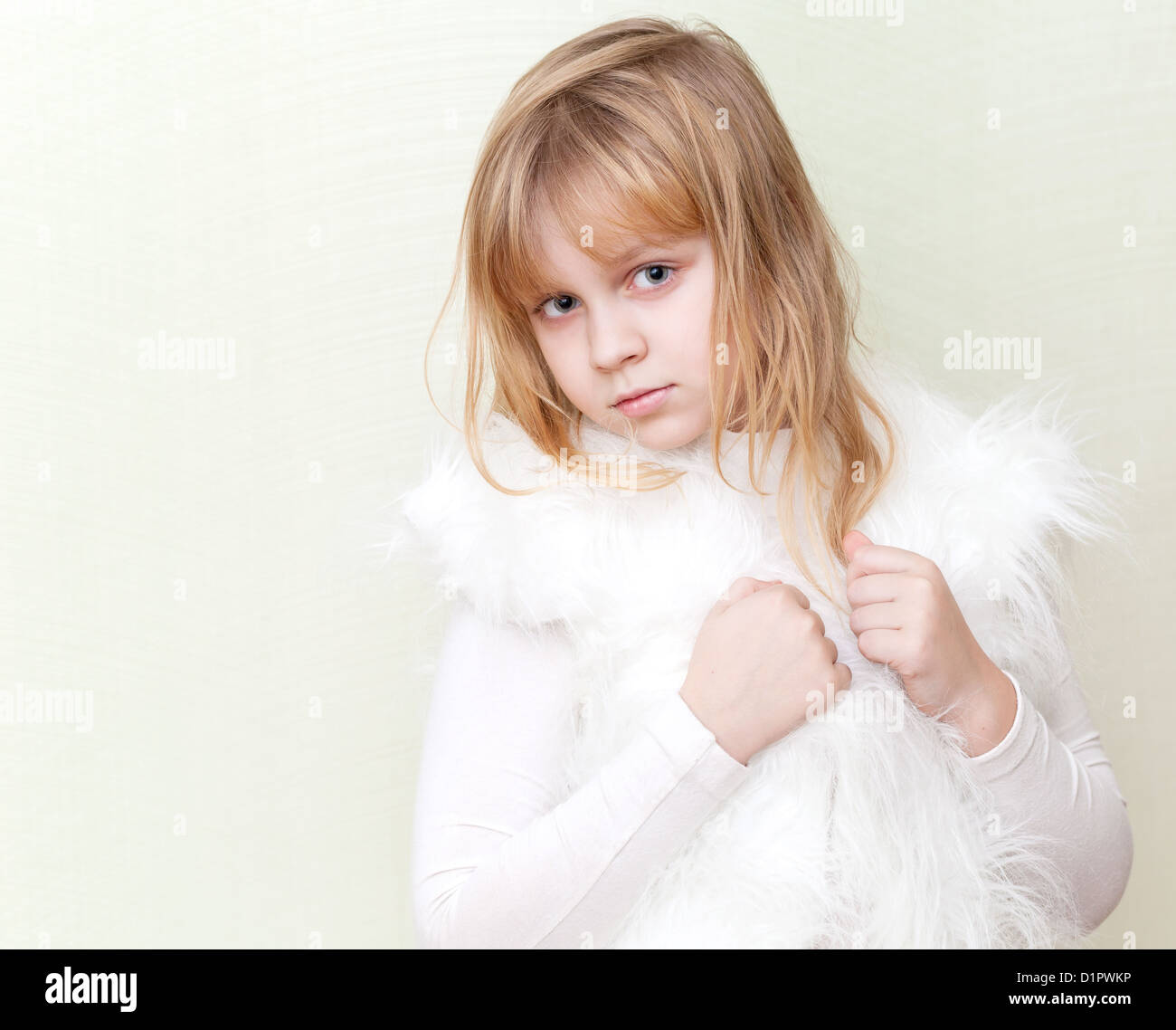 Little blond girl in white fluffy fur vest Stock Photo Alamy
