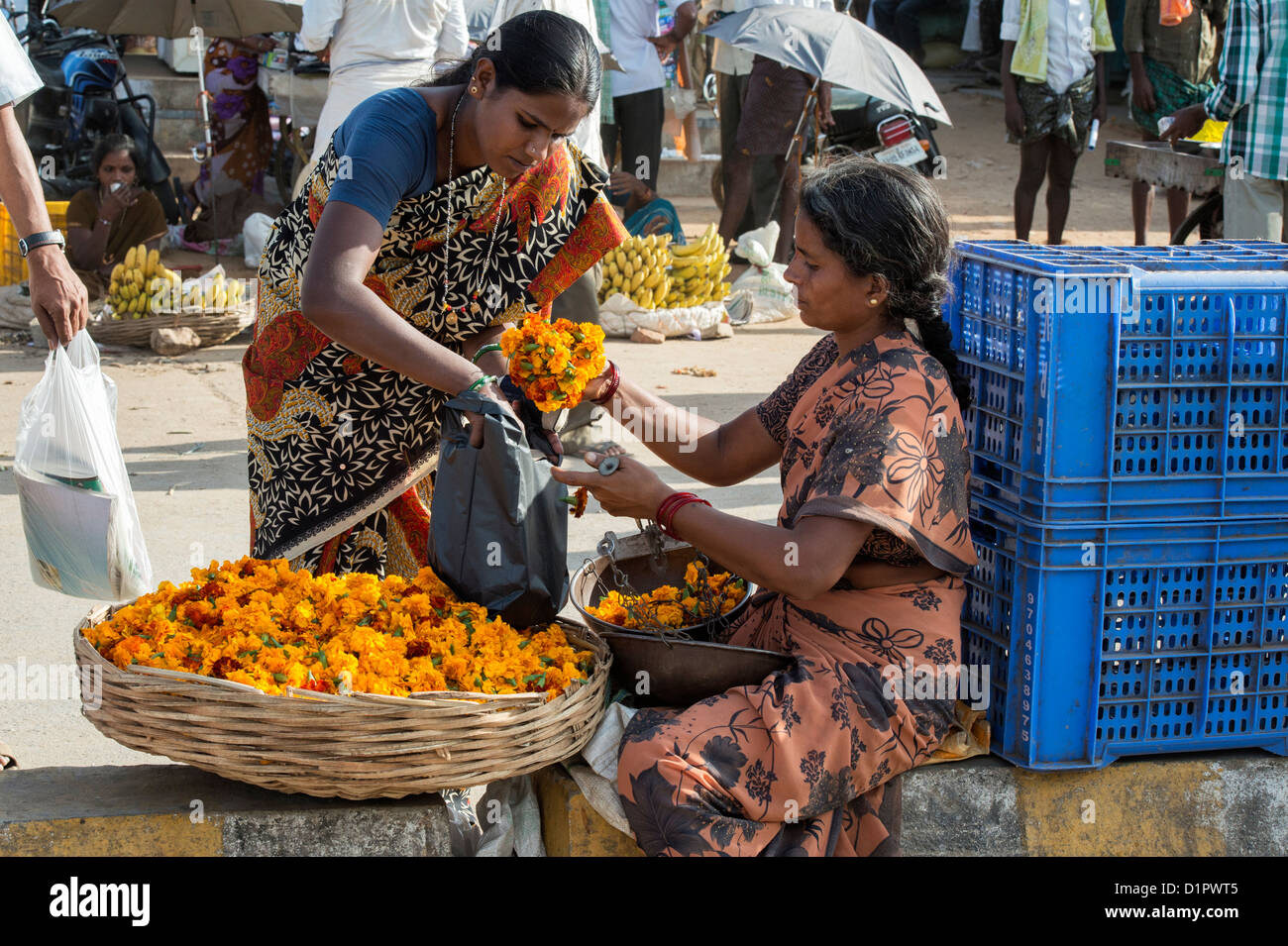 Indian woman selling Marigold flowers in a basket for hindu puja