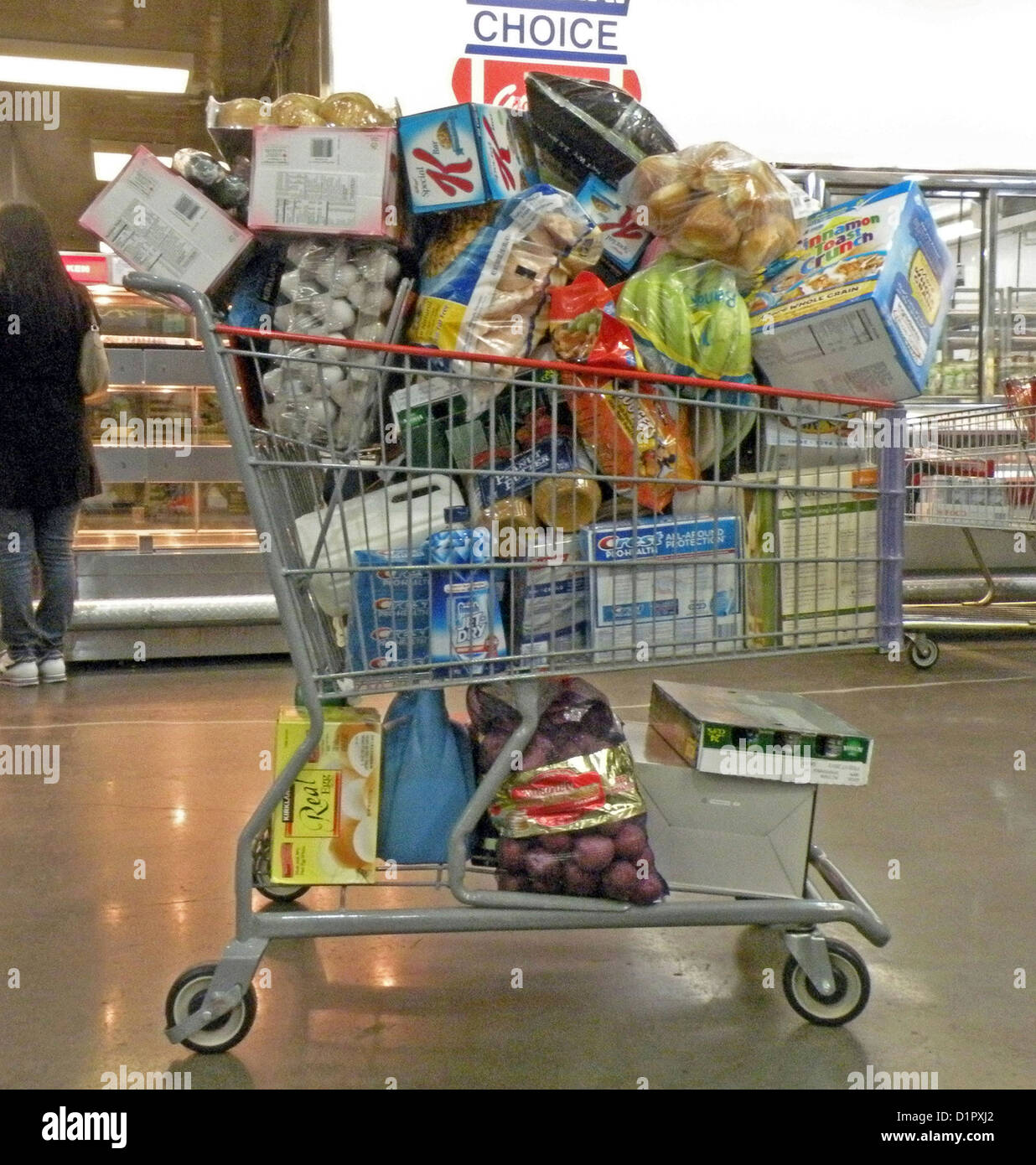 Overloaded shopping cart at Costco discount market in Queens, New York Stock Photo