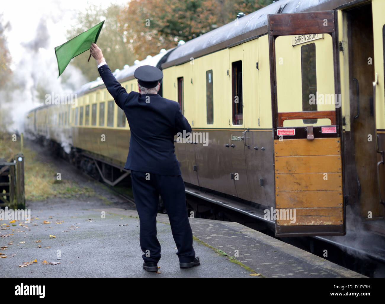 train guard signaling for train to depart Stock Photo Alamy