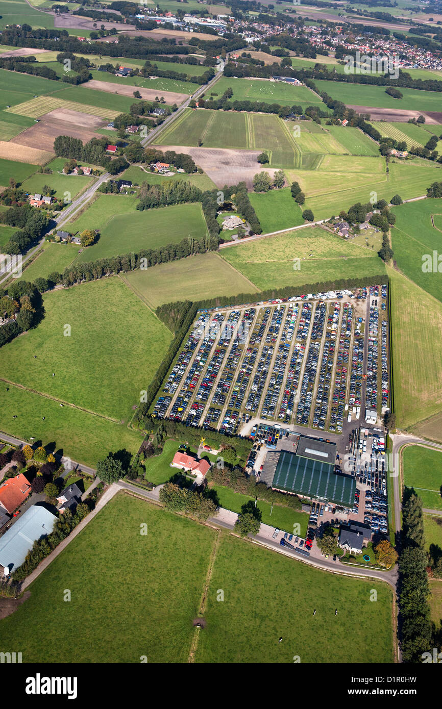 The Netherlands, near Almelo, Car scrap yard, surrounded by farms and farmland. Aerial. Stock Photo