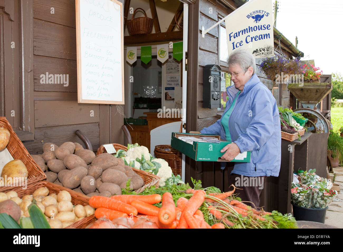 Local woman delivering locally produced cakes to organic Stock