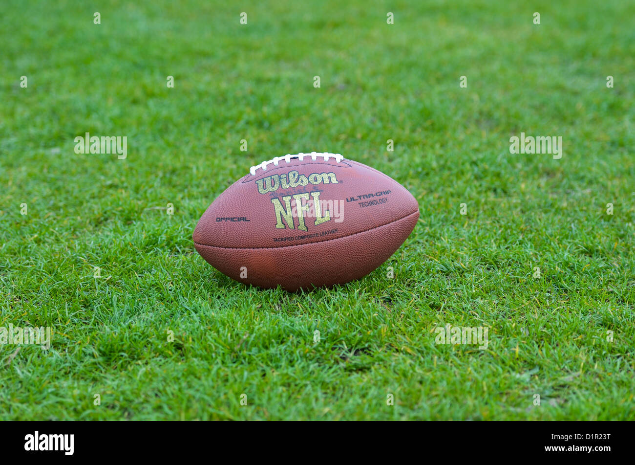 American Football Ball on Grass Stock Photo