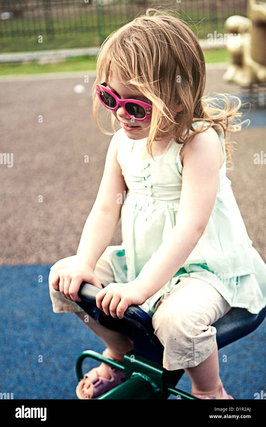 Girl on seesaw at the park Stock Photo Alamy