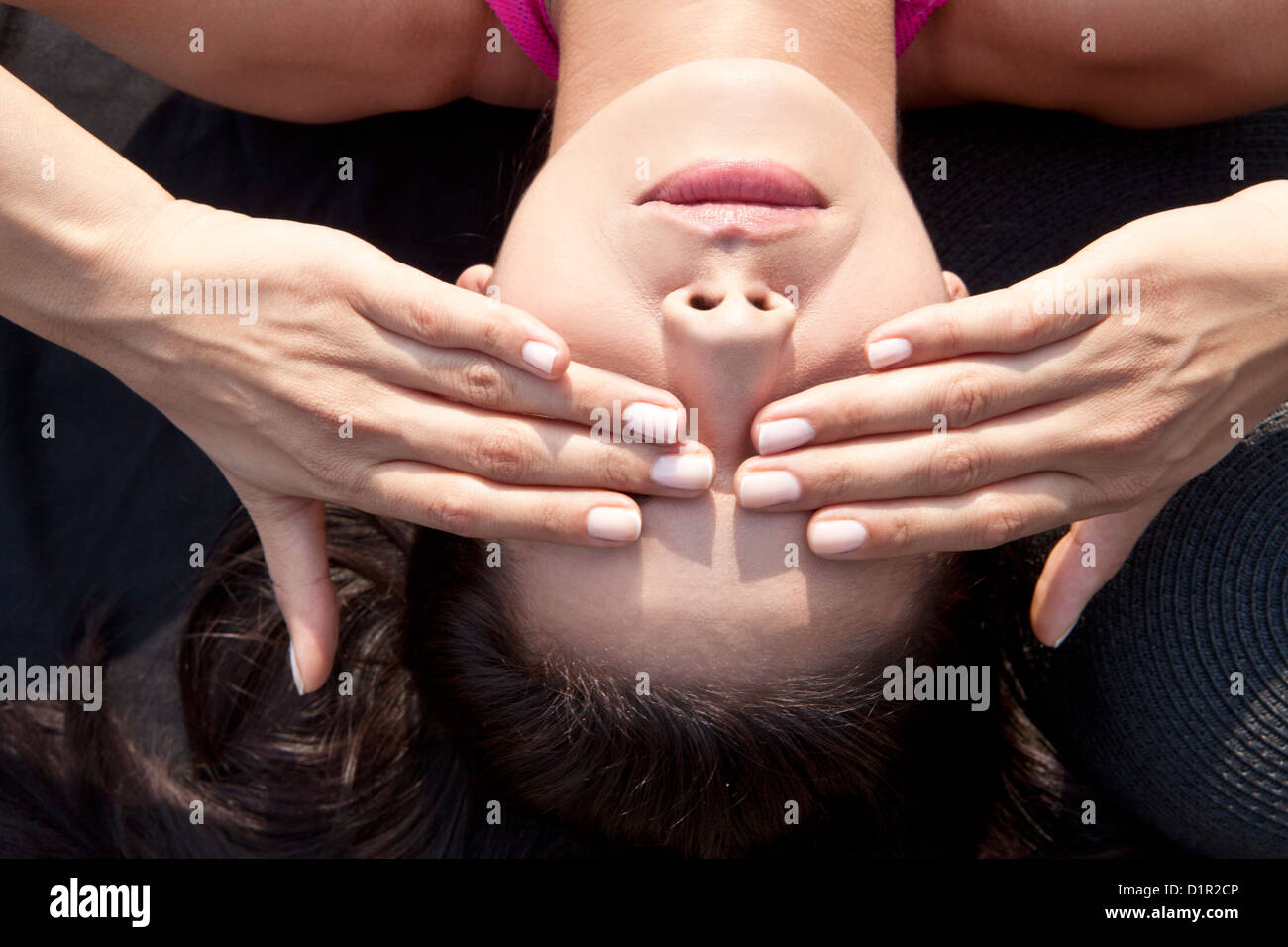 woman protects her eyes from the sun Stock Photo