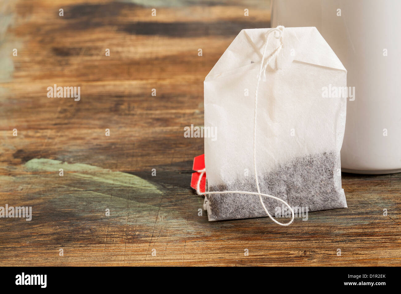 tea bag with tea cup on grunge painted wood Stock Photo