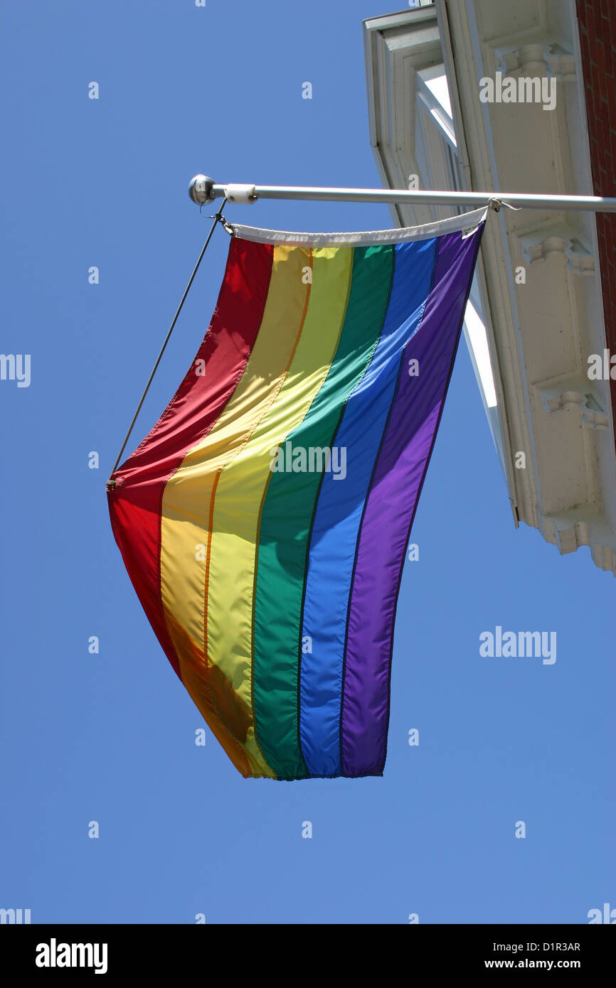 A gay pride flag hanging from a building in Montreal, Quebec Stock Photo