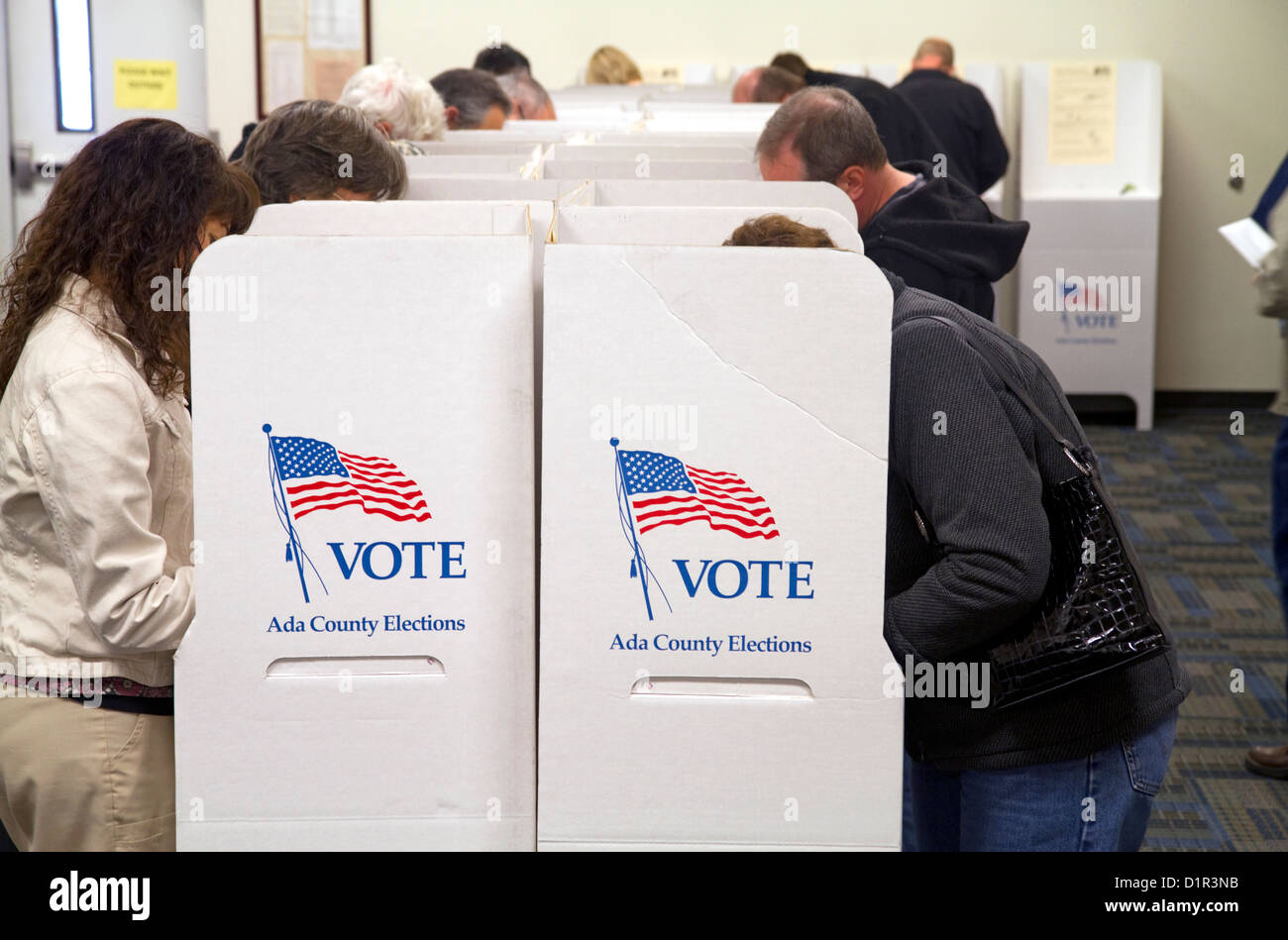 People vote in cardboard voting booths at a polling station in Boise