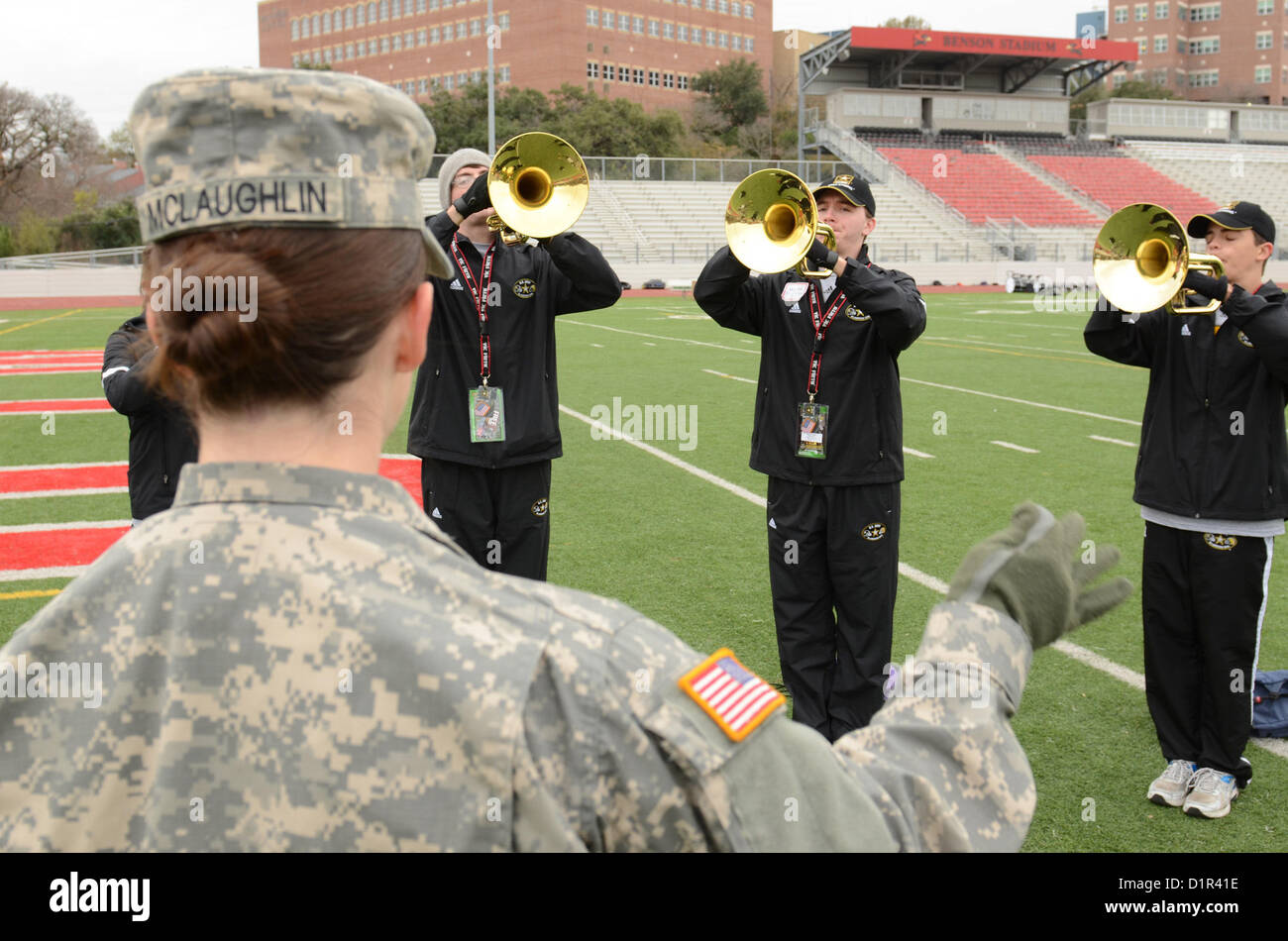 Staff Sgt. Becky McLaughlin conducts members of the U.S. All-American Band at Benson Stadium in San Antonio Jan. on 2, 2013. The U.S. Army All-American Band are scheduled to perform during the U.S. Army All-American Bowl on Jan. 5. (U.S. Army photo by Pfc. Victor Blanco, 205th Public Affairs Operations Center) Stock Photo