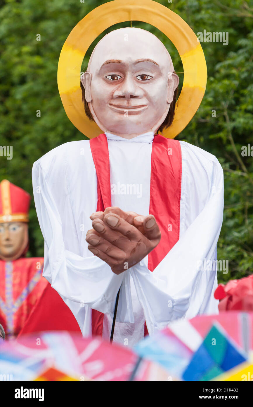 A large carnival puppet with a golden halo. St Albans, UK 2012 Stock Photo