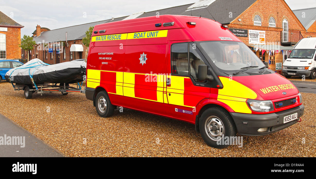 A Red Fire Service Van With A Trailer Caryring A Dinghy The Van Is a-red-fire-service-van-with-a-trailer-caryring-a-dinghy-the-van-is