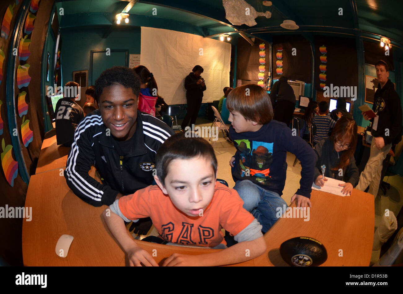 Players from the Army All-American Bowl visit The Boys and Girls Club in San Antonio Jan. 2. Several players enjoy showing off their video highlights to the children in the technology room at The Boys and Girls Club. (U.S. Army Reserve photo by Spc. Jared Taylor, 205th Public Affairs Operations Center) Stock Photo