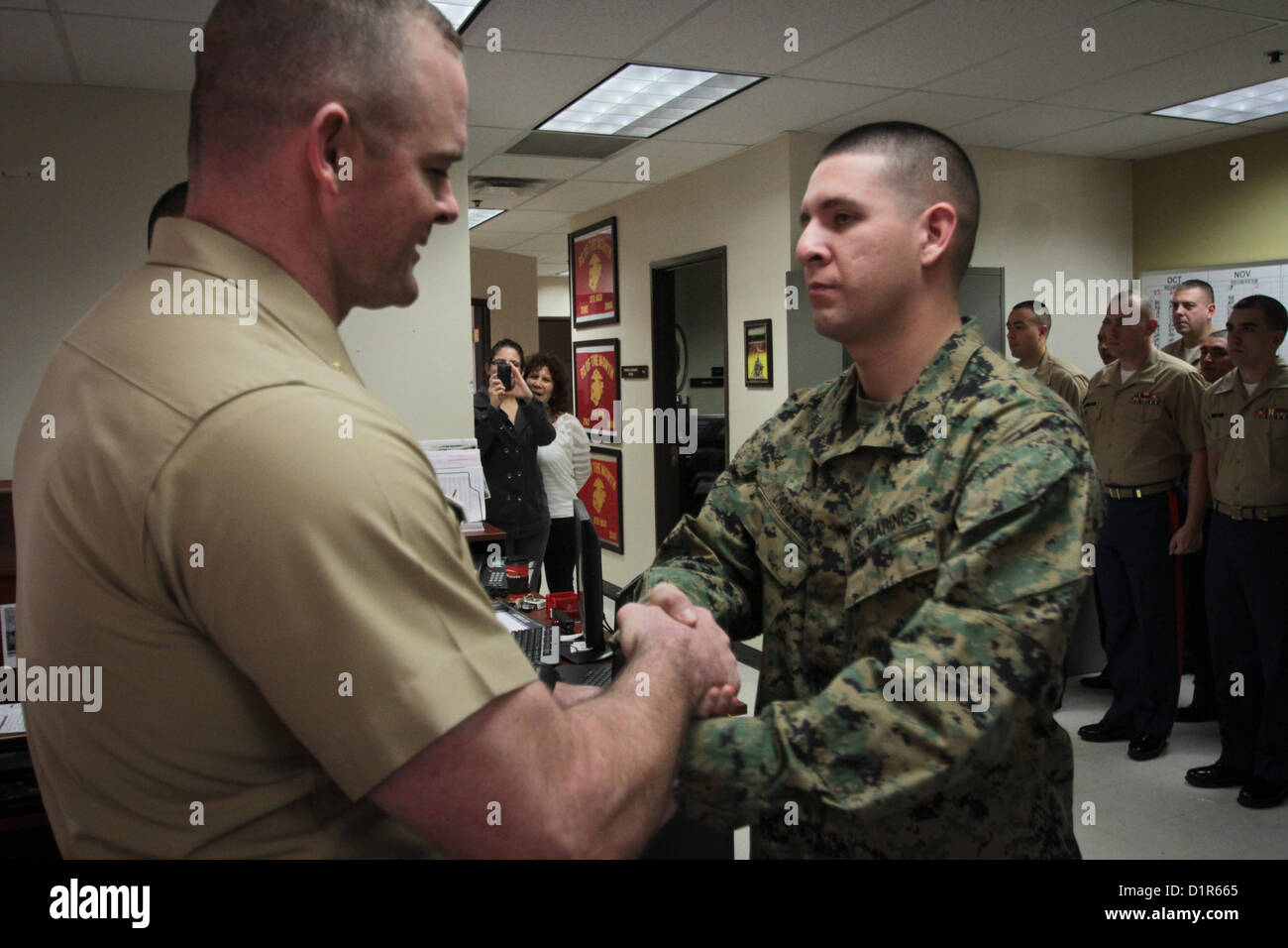 Maj. Steven M. Ford, commanding officer of Marine Corps Recruiting Station Phoenix, congratulates Staff Sgt. Hector E. Orozco, upon being meritoriously promoted from sergeant to staff sergeant during a ceremony at the R.S. Phoenix Headquarters in Phoenix, Jan. 2, 2013. Orozco, a native of Los Angeles, and an aircraft electronic countermeasures systems technician by trade, has been a recruiter in the Phoenix region since July, 2011. 'To get promoted is one thing. Everybody out here on recruiting duty is hand selected and personally screened, so you're already dealing with an A-List group of peo Stock Photo