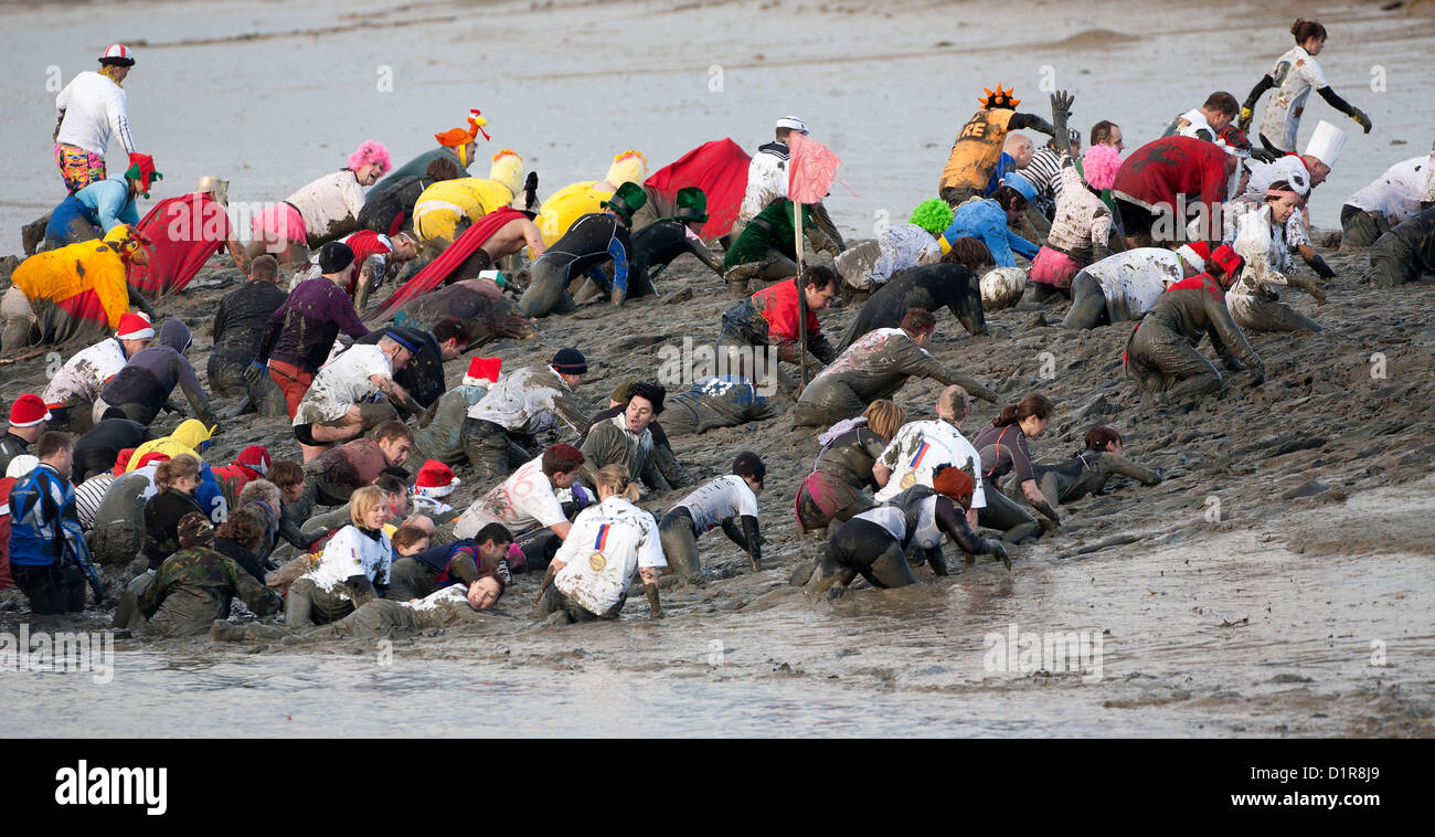 Competitors struggle through the thick mud during the annual Maldon Mud Race in Maldon in Essex. Stock Photo