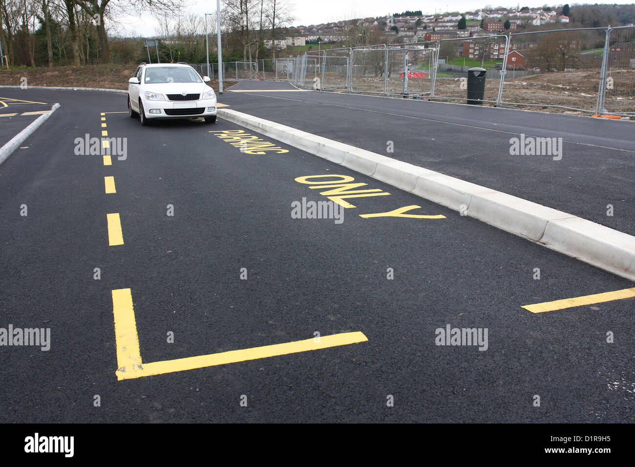 New bus parking bay at a large senior school with a car parked in it, 13th January 2013 Stock Photo