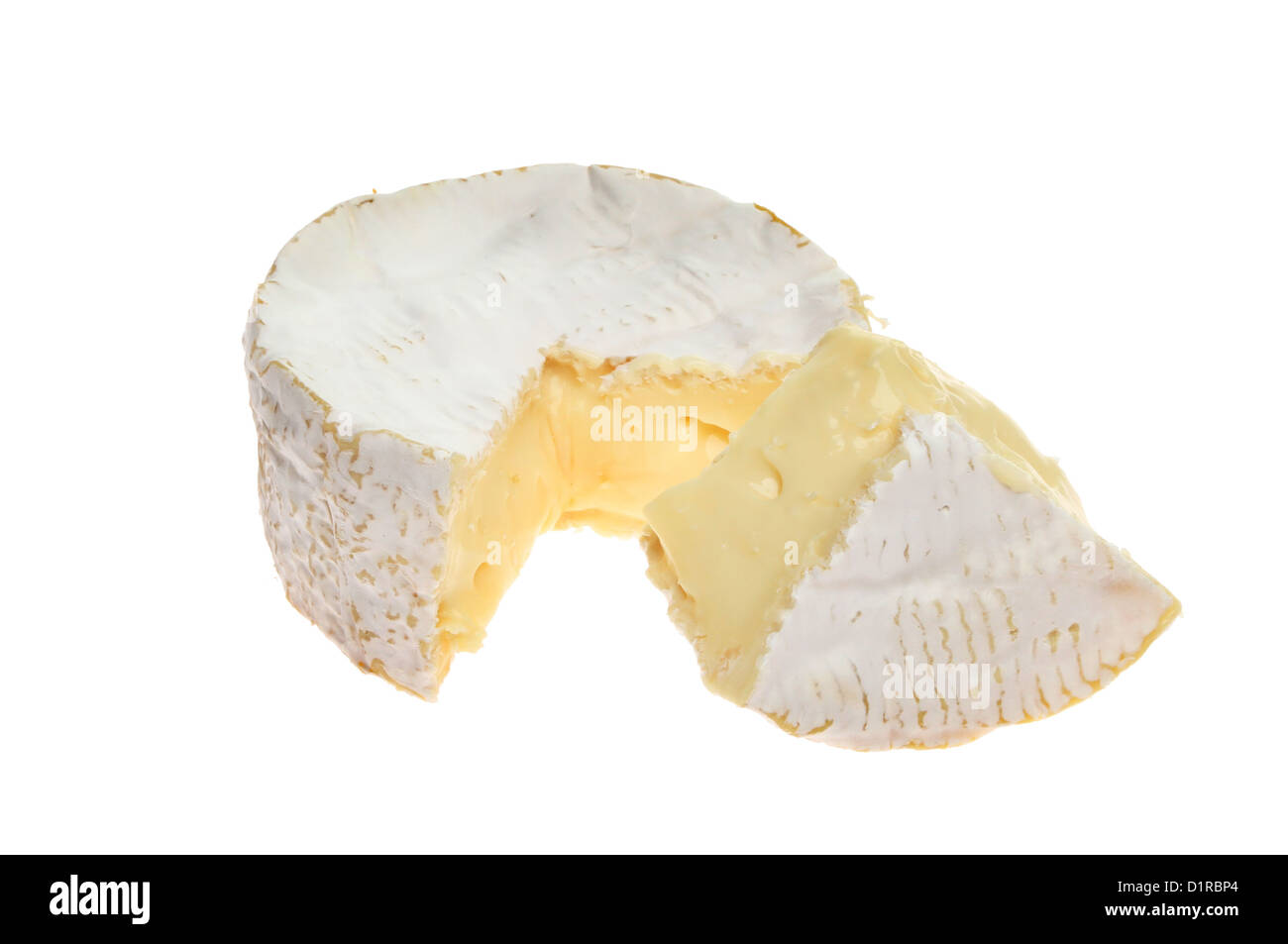 Soft creamy camembert cheese with a portion cut out isolated against white Stock Photo