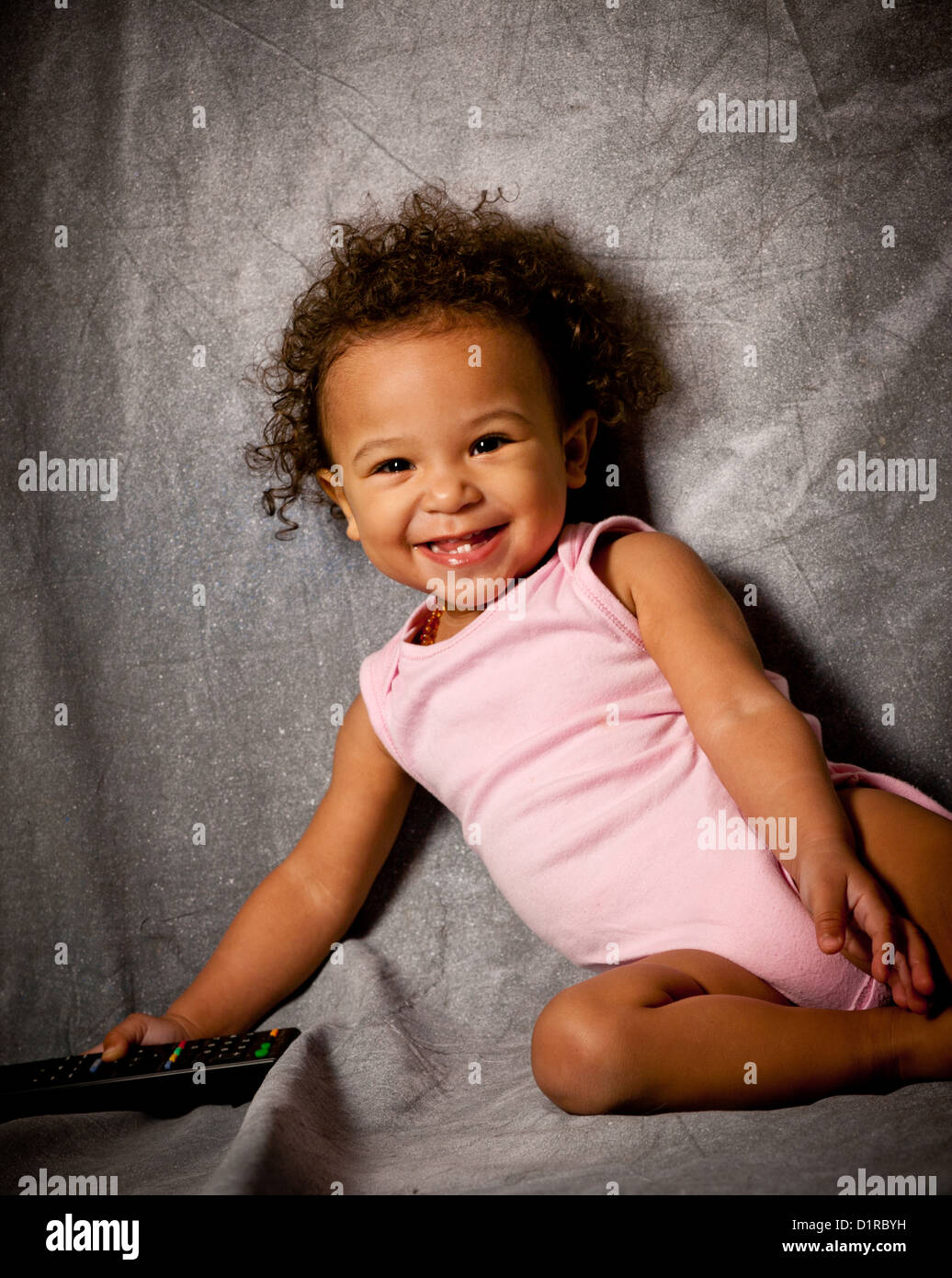 Studio Portrait Of A Cute Baby Girl 18 Months Mixed Race Stock