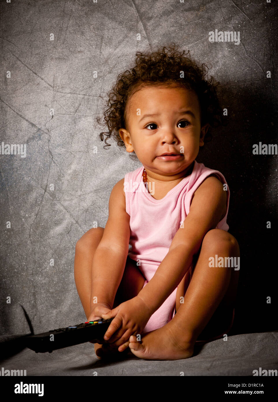 Studio Portrait Of A Cute Baby Girl 18 Months Mixed Race Stock