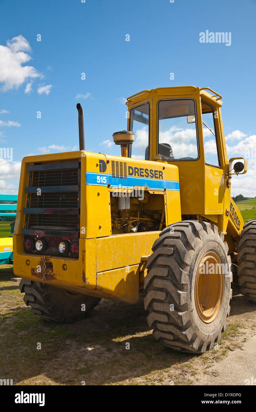 A yellow farm tractor. Farm in Northland, North Island, New Zealand. Stock Photo