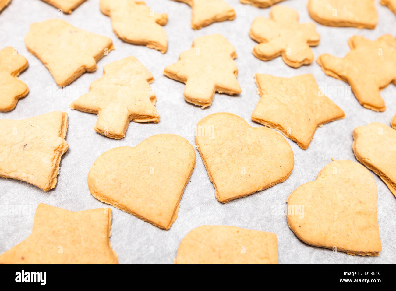 Simple homemade Christmas cookies on a white cooking paper Stock Photo