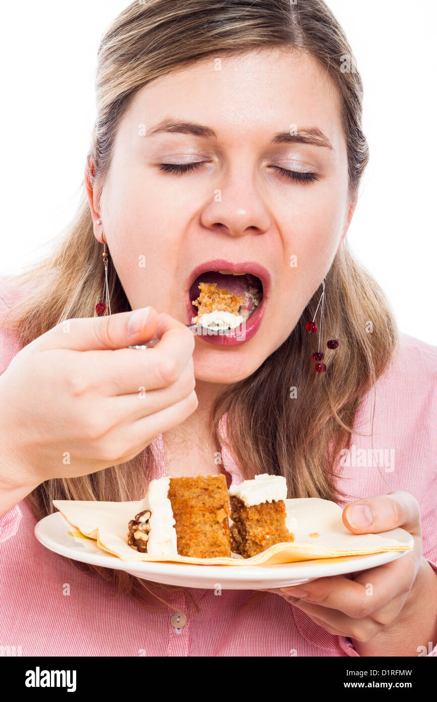 Close up of young woman eating carrot cake. Stock Photo