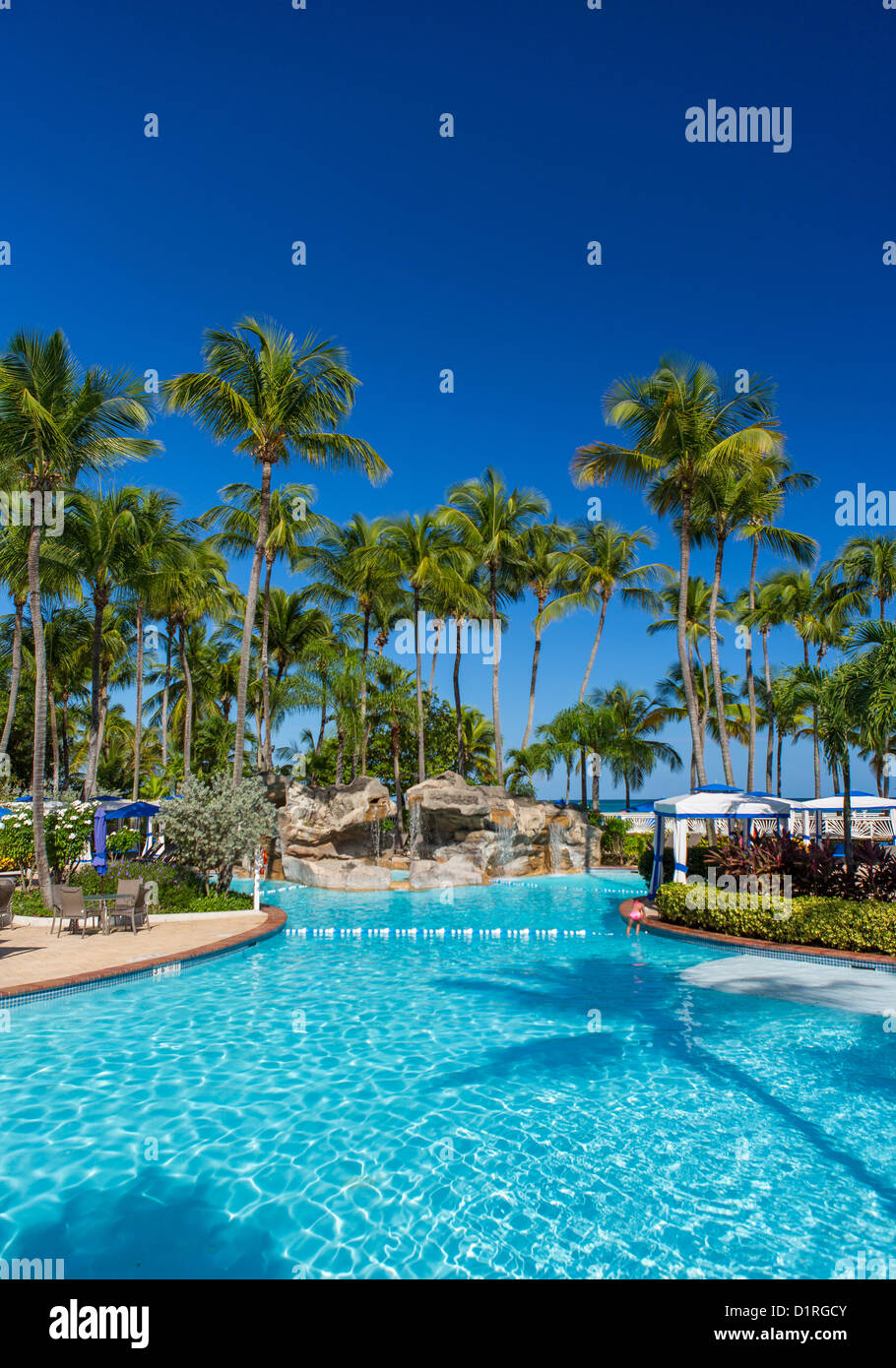 SAN JUAN, PUERTO RICO - Swimming pool at InterContinental Hotel, a beach resort at Isla Verde. Stock Photo