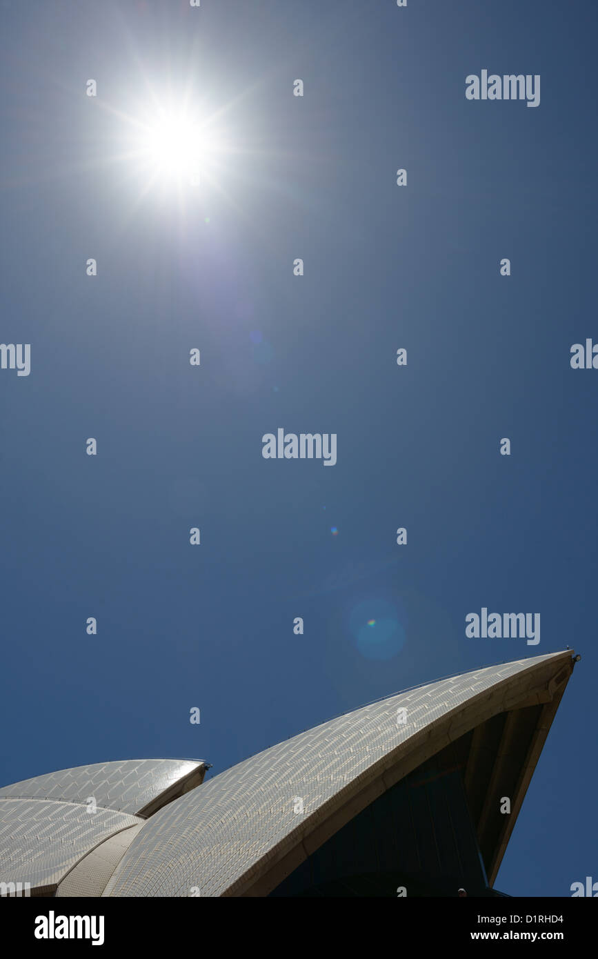SYDNEY, Australia - SYDNEY, Australia - The roof of the Sydney Opera House against a clear blue sky and with the summer sun in the top of the frame. Stock Photo