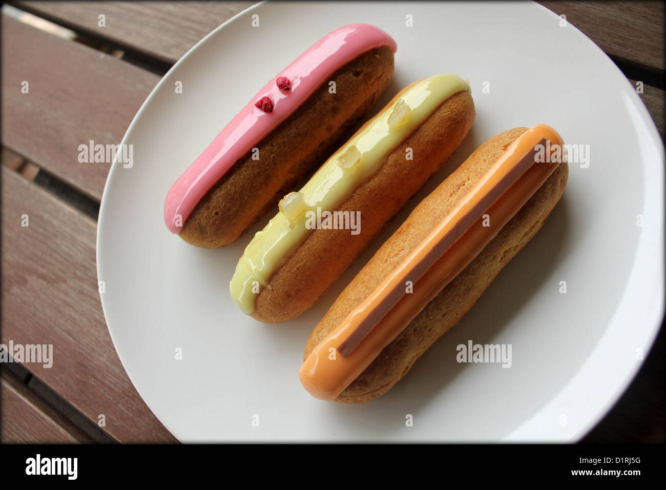 3 fruit eclairs on a white plate Stock Photo